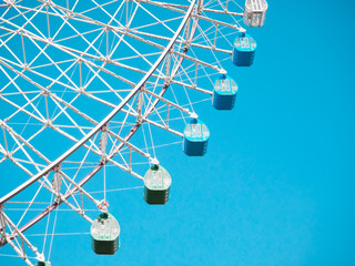 Ferris Wheel Over Blue Sky Background