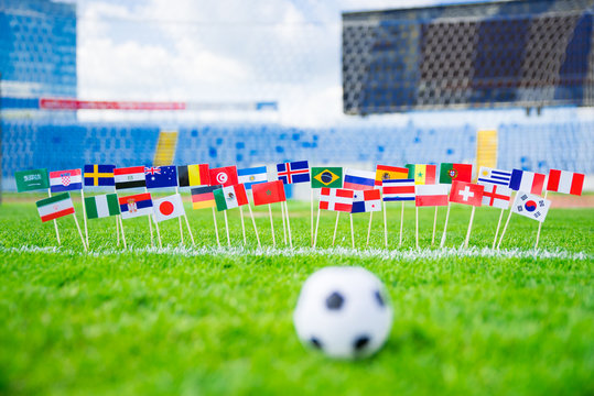 Flags of all football nations on green grass. Football ball, Fans, support photo, edit space
