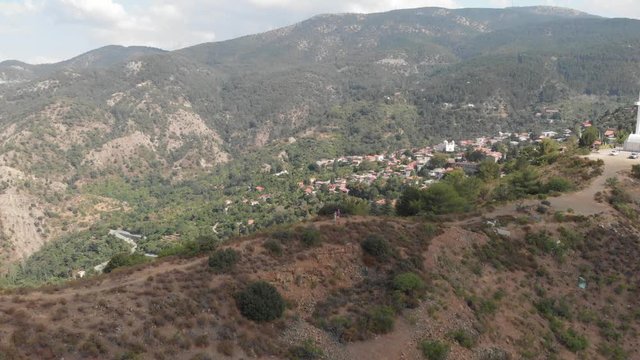Aerial drone view of mountains including small mountain village