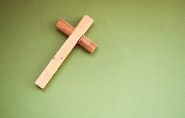 Wooden cross on a green background, easter day, world prayer day, international prayer day
