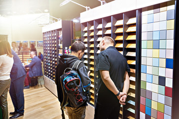 Men in shop of colored wooden panels
