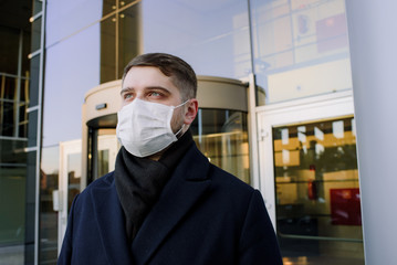 Caucasian young man with face mask to protect from coronavirus covid-19 covid 19 virus global...
