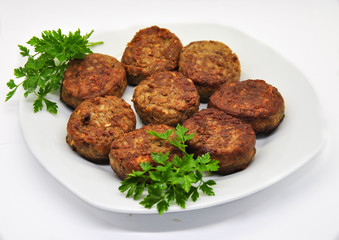 meat fried meatballs and parsley on a white plate