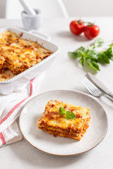 Delicious Homemade Italian Lasagna with bolognese and bachamel Sauce on white Background. Hot Tasty Lasagna with Parmesan Cheese. Restaurant menu, recipe
