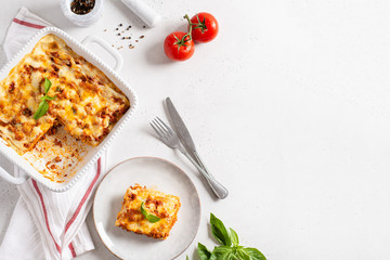 Delicious Homemade Italian Lasagna with bolognese and bachamel Sauce on white Background. Hot Tasty Lasagna with Parmesan Cheese. Restaurant menu, recipe. Copy space