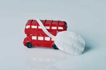 Fotobehang miniature of red double-decker bus and face mask © nito