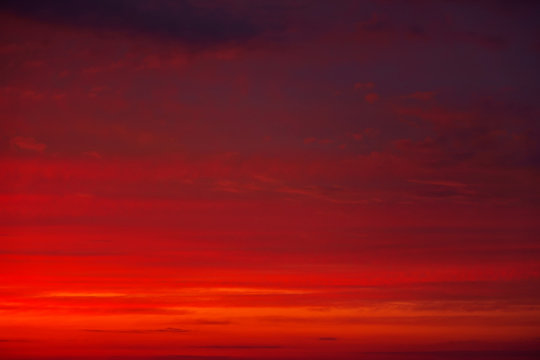 Beautiful Twilight sky background. Colorful Fiery orange and red sunset sky.