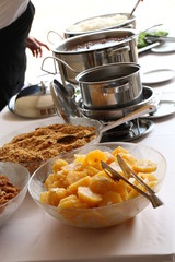 pan with food on the table, feijoada, party during the day, farofa, pineapple, beans in the pan