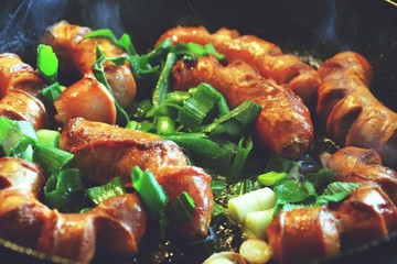 Grilled sausages with green vegetables, close up food photo