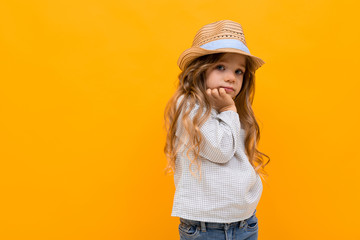 stylish young girl posing isolated on a yellow studio background