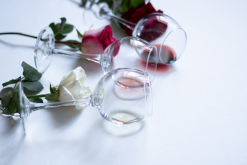romantic dinner table setting with wine glasses and roses