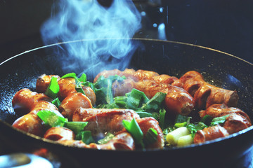 Cooking sausages with green vegetables, close up food photo