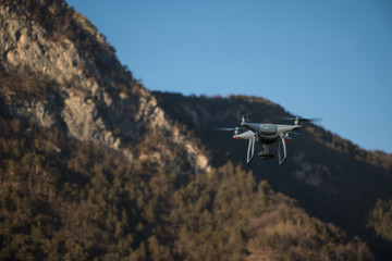 drone in flight over mountains in a sunny day