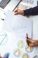 The designer draws a sketch of the logo.