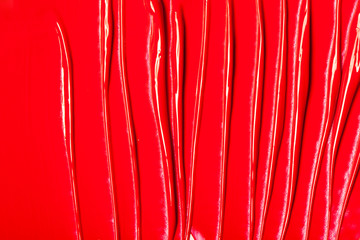 A trace of red lipstick on a white background.