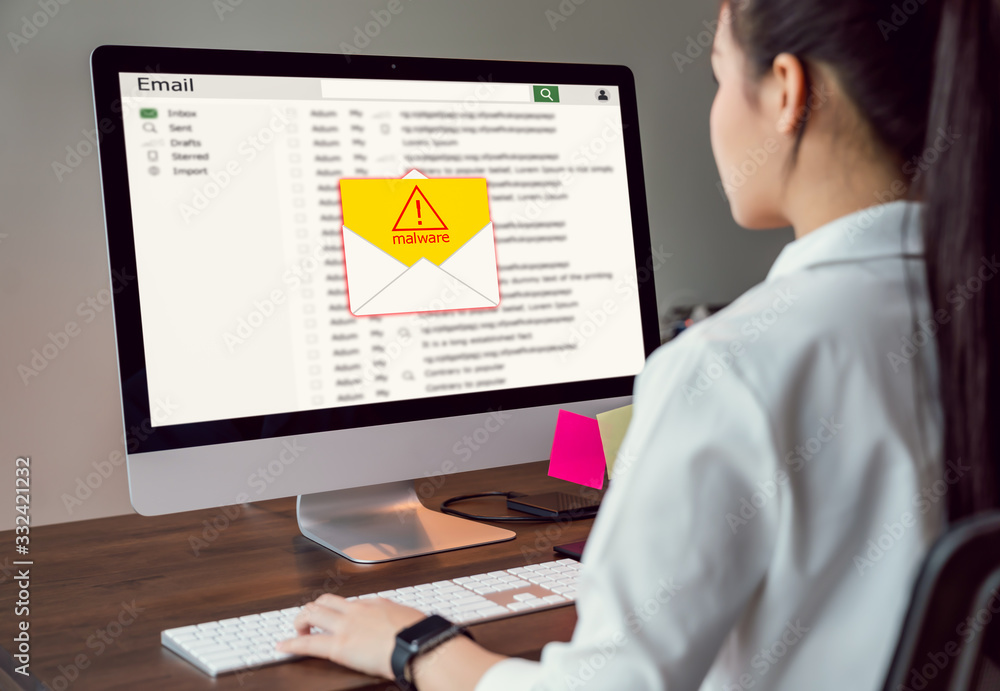 Poster concept of cyber crime, businesswoman using computer and show malware screen that comes with email, 