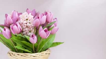 Beautiful artificial tulips in a wicker basket.