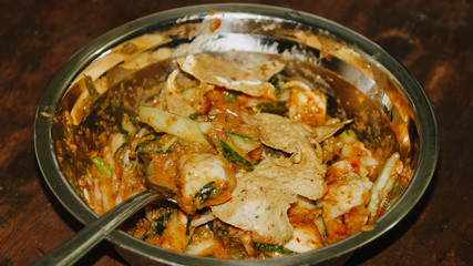 Close-up of Pecel - Traditional Javanese salad, consisting of mixed vegetables in a peanut sauce dressing, served with omelet.