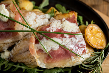 Sea bream stuffed with cream cheese and smoked ham with young potatoes and leek