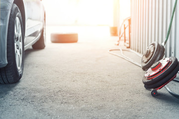 Car wheel repair shop outdoor ground . Seasonal winter tyre change at workshop. Vehicle tire...