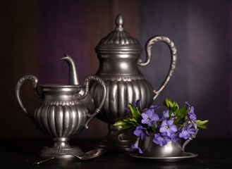 Vintage still life witha bouquet of spring flowers and pewter