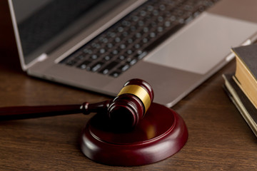 Notary concept. Wooden gavel near the laptop