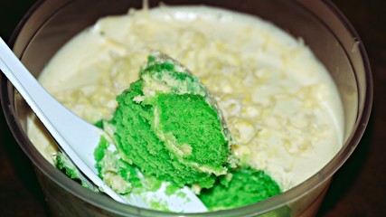 Close up Pandan leaf cheesecake on wooden background. Selective focus depth of field. (image contain certain grain or noise and soft focus when view at full resolution).