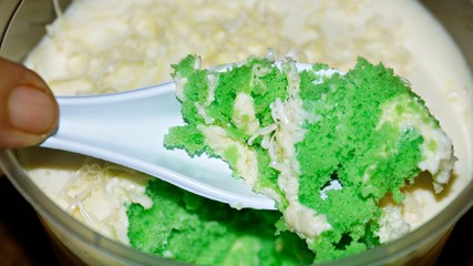Close up Pandan leaf cheesecake on wooden background. Selective focus depth of field. (image contain certain grain or noise and soft focus when view at full resolution).