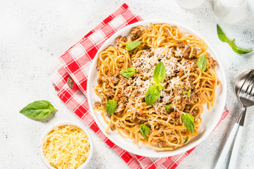 Pasta Bolognese in white plate top view.