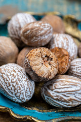 Dried nutmegs nuts in vintage bowl
