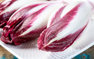 Fresh organic Belgian endivi or red chicory lettuce close up