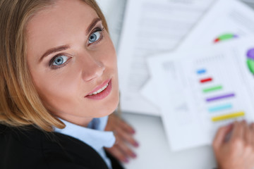 Beautiful smiling businesswoman portrait at workplace look in camera. White collar worker at...