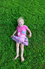 happy little girl on green grass