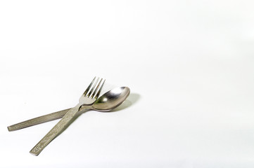 Made of stainless steel, spoon and fork together arranged or isolated on a white background