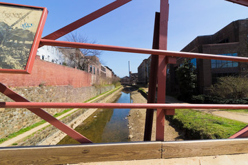 Creative view looking eastwards along the Chesapeake & Ohio Canal from a public footbridge in...