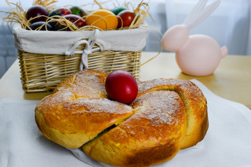 Easter table with Easter cake and Easter colored eggs