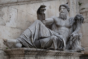 Antique Roman statue of Neptun who appears to be taking a selfie