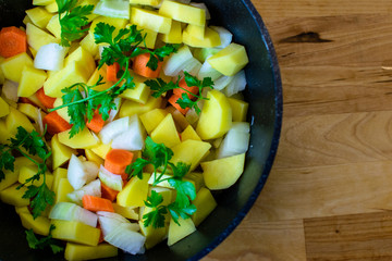 Various fresh vegetables in a black pot - colorful fresh soup