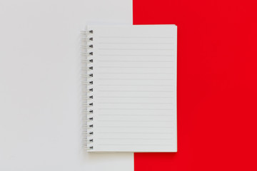 white Notepad with springs on a white and red background