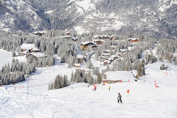 Fototapeta premium Skiing and snowboarding people in ski resort by winter 
