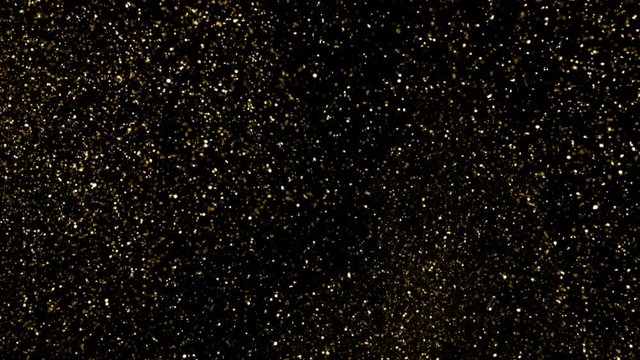 Golden glitter underwater background. Gold particles shining in water on black background. Gold dust beautiful abstract background