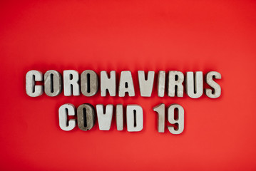 inscription from the letters 3D coronavirus covid 19 on a red background in isolation pandemic virus