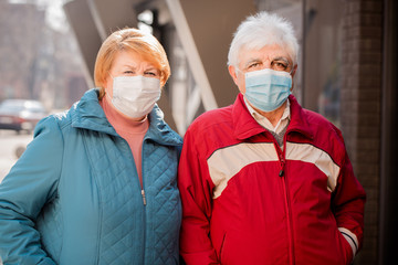 an elderly couple in protective masks