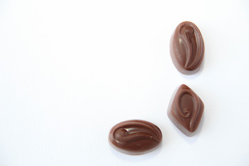 Assortment of delicious chocolate candies isolated on white background.