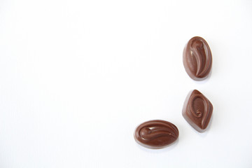 Assortment of delicious chocolate candies isolated on white background.