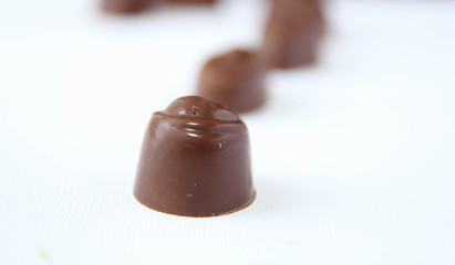 Assortment of delicious chocolate candies isolated on white background.