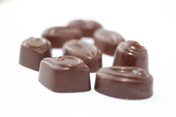 Assortment of delicious chocolate candies isolated on white background.