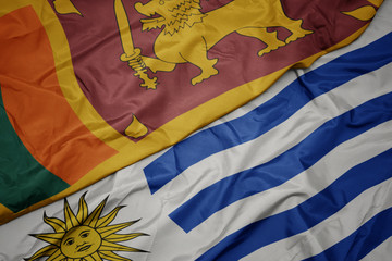waving colorful flag of uruguay and national flag of sri lanka.