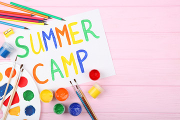 The inscription "summer camp" on a colored background top view.