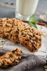 Homemade oatmeal cookies with chocolate. Milk and mint on the background.